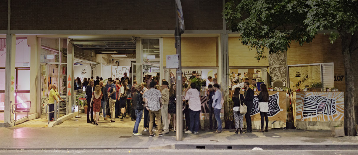 A crowd gathers out the front of 107 Redfern