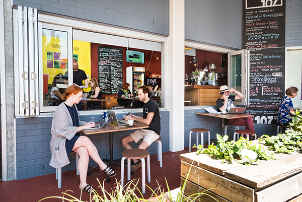 Two people share an outside table in the Redfern Street co-working space