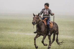 photo of man riding a horse